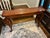 A mid-to-late 20th century vintage reproduction (1950s–1990s), Baker Furniture- style with a rich mahogany tone, solid...