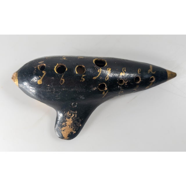 We are selling this great Italian-American black and gold painted terracotta pottery Ocarina. The ocarina has impressed GB...