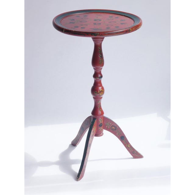 An antique Folk Art wine table made in the Netherlands. The plant stand is painted in red with floral details. The...