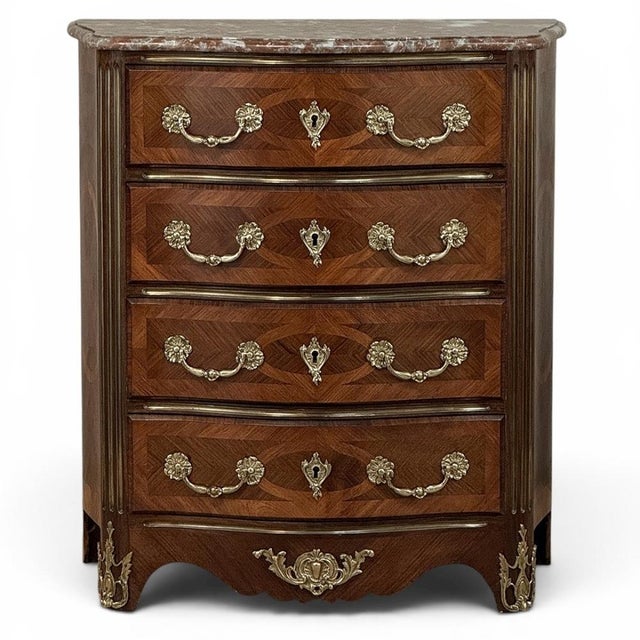 The enduring elegance of French design is beautifully expressed in this 19th century antique commode, where graceful...