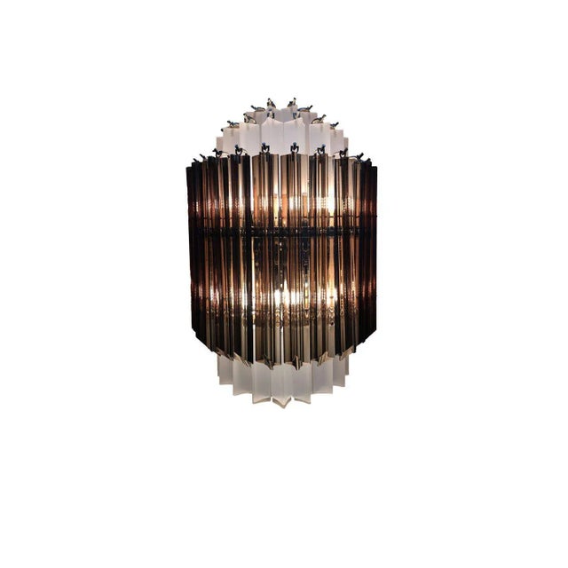 Contemporary fume’ Quadriedro and sand-blasted Triedro Murano Glass Wall Sconce Five levels of Murano glass. Metal frame...