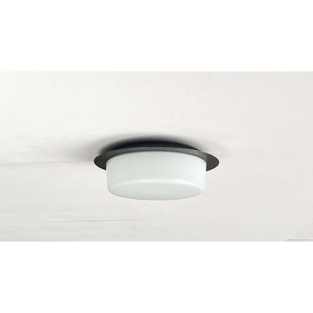 Minimalist ceiling lights from the GDR era. The design impresses with its minimalist aesthetic. The light consists of a...