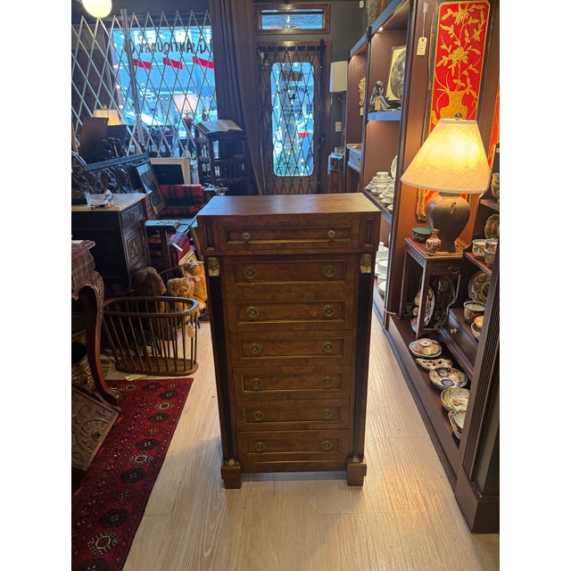 A striking French Empire–style lingerie chest, elegantly scaled and richly detailed, featuring a dramatic black marble top...