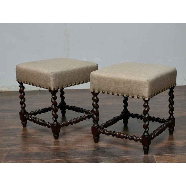 This pair of 19th-century English stools showcases the timeless elegance of barley twist craftsmanship. The dark brown...
