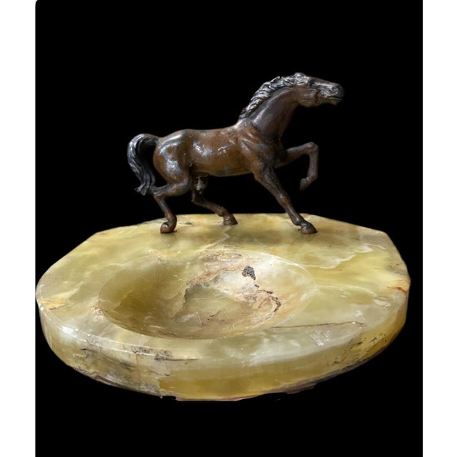Bronze/metal horse standing on a beautiful green onyx slab. Could be used as ashtray or a unique catch all dish.