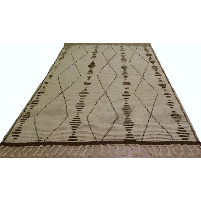 Hand-knotted with care using traditional rug making techniques, this wool rug blends timeless craftsmanship with a modern...
