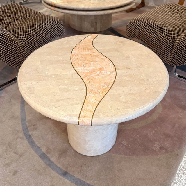 A beautiful vintage tessellated travertine side table with tessellated coral inlay and brass trim detailing. A beautiful...
