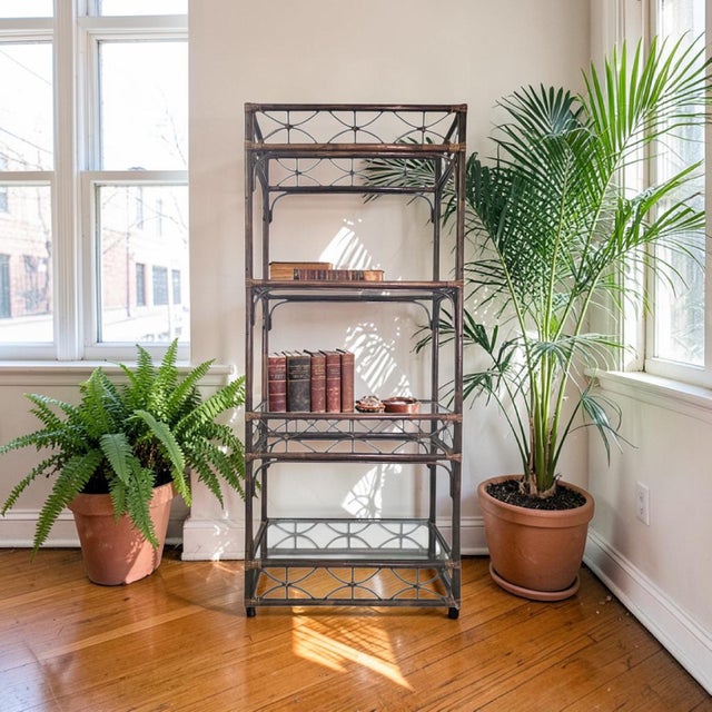A vintage rattan and bamboo étagère dating to the 1970s, executed in an open architectural form with integrated glass...