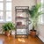 A vintage rattan and bamboo étagère dating to the 1970s, executed in an open architectural form with integrated glass...