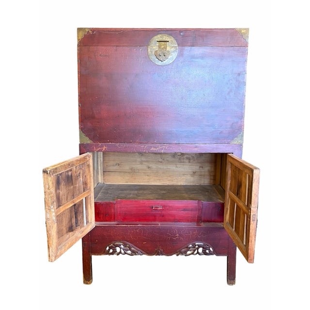 A striking antique Chinese wedding cabinet, also known as a dowry cabinet, showcasing the timeless elegance of traditional...