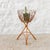 Handmade vintage planter with elegant curved lines. Bamboo frame with three legs and a rattan basket with a vinyl base...