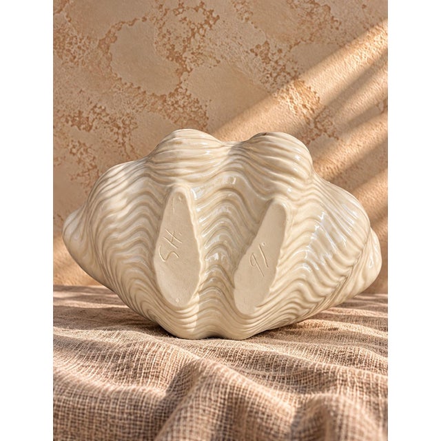 Charming vintage set of three sculptural ceramic seashell dishes featuring glossy blush pink interiors and beautifully...