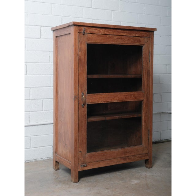 This vintage Indian display cabinet is crafted from solid teak and features a beautifully weathered surface that...