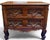 A charming early 19th-century French Provincial Louis XV petite commode, handcrafted in richly figured walnut and dating...