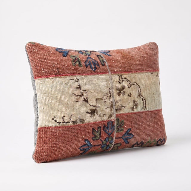 This 16'' x 24'' pillow cover was made from an authentic Turkish rug — terracotta patchwork panels with ivory floral...