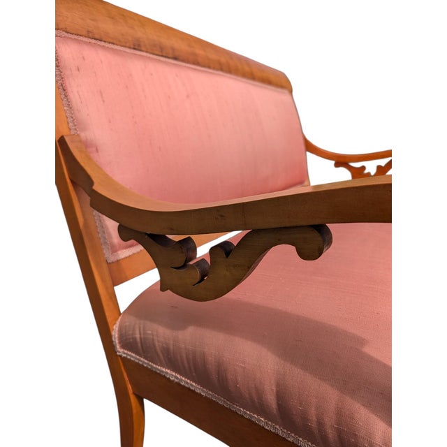 An elegant late 19th-century American/Continental Neoclassical settee defined by a rolled crest rail, pierced acanthus arm...