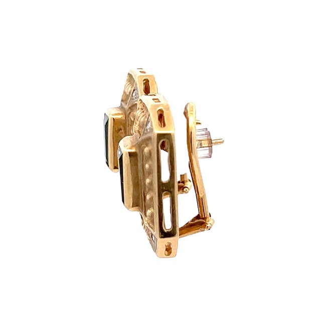 Sculptural Italian earrings crafted in 14K yellow gold and centered with emerald-cut green tourmalines totaling...