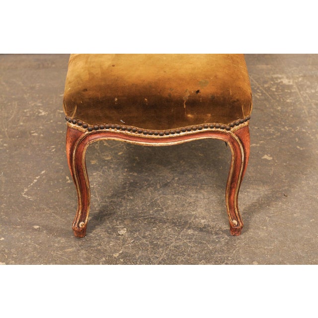 A French upholstered smaller-sized bench from the 19th century. This antique bench from France, just shy of 3 feet in...