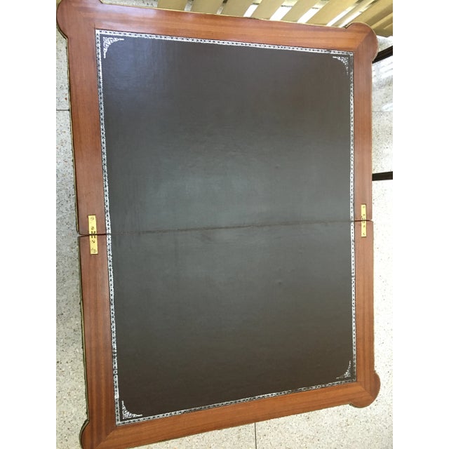 Game table with leather inlay woodwork and bronze. Opens up.