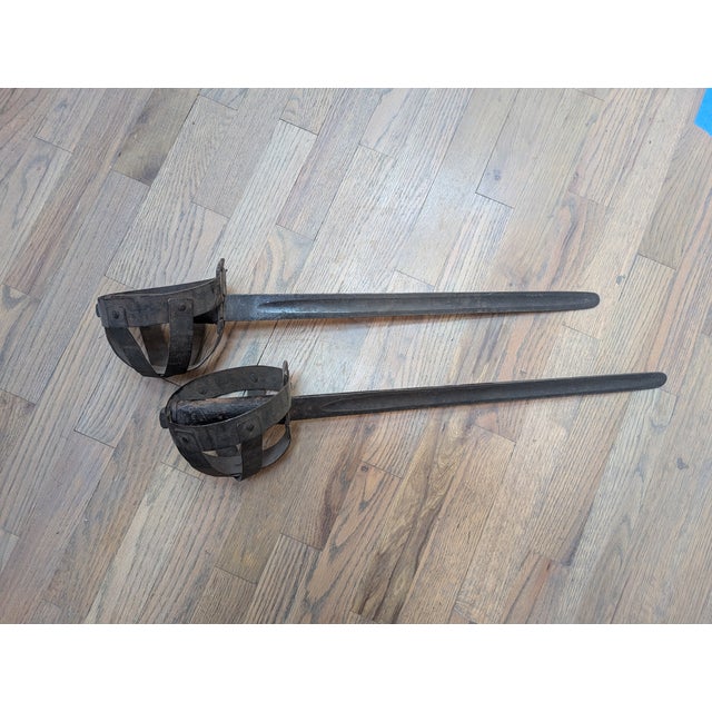 Traveling Man Treasures curiosity Vault is selling this rare pair of basket-handled cutlass' were made by E. Woods and...