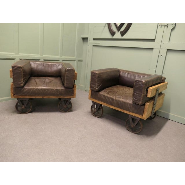 A Pair of Wood Framed Industrial Designer Club Chairs The chairs have Solid Wooden Frames and are set on cast iron railway...
