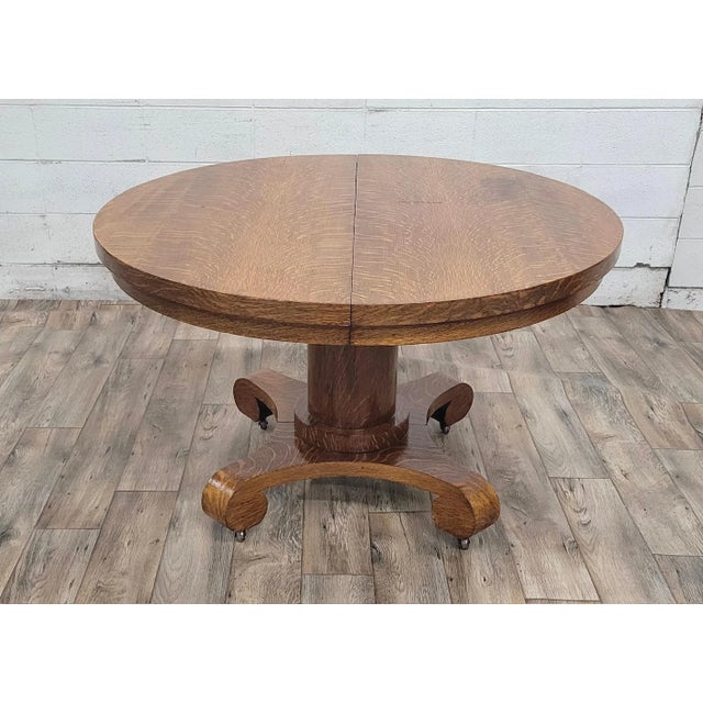 This is a gorgeous vintage American Empire Mission Oak Arts and Crafts style 48” round scroll foot pedestal extension...