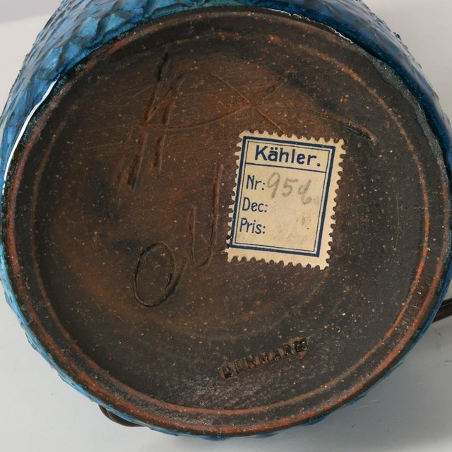 Table lamp made of partly blue-glazed stoneware with slim neck and relief pattern. Signed “Nils HA Denmark” on the bottom....