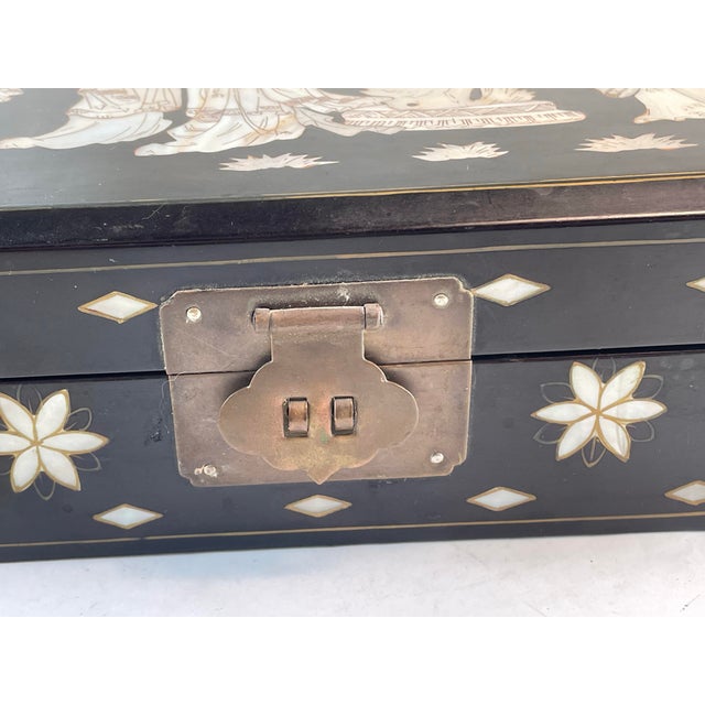 Here is a fine quality heavy black lacquer jewelry box with a wonderful line carved mother of pearl inlay geisha girl...