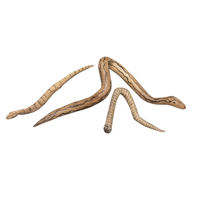 Vintage tribal set of three hand-carved wooden snakes from Papua New Guinea. Each piece is fashioned from light-brown wood...