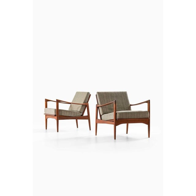 This rare pair of kandidaten easy chairs, designed by ib kofod-larsen and produced by ope in sweden during the 1950s,...