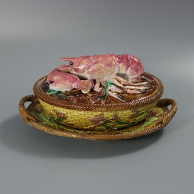 George Jones Majolica dish with cover which features a three piece set, with a lid, dish and undertray. A lobster sits on...