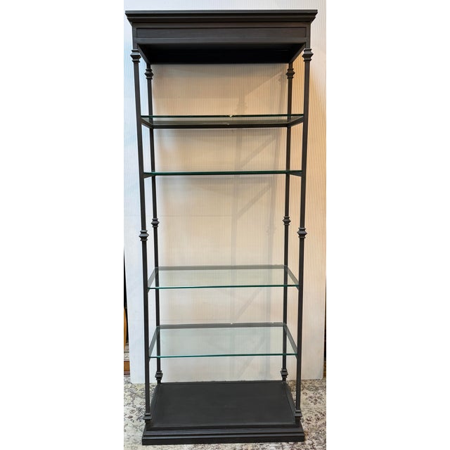 Design Plus Gallery presents a Black Metal with Glass Shelving Etagere. This shelving unit is solid, likely with a frame...