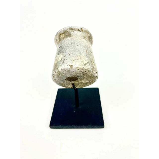 An aluminum lip plug from the Kirdi people. A prestige object used in body modification, there is a wonderful sculptural...