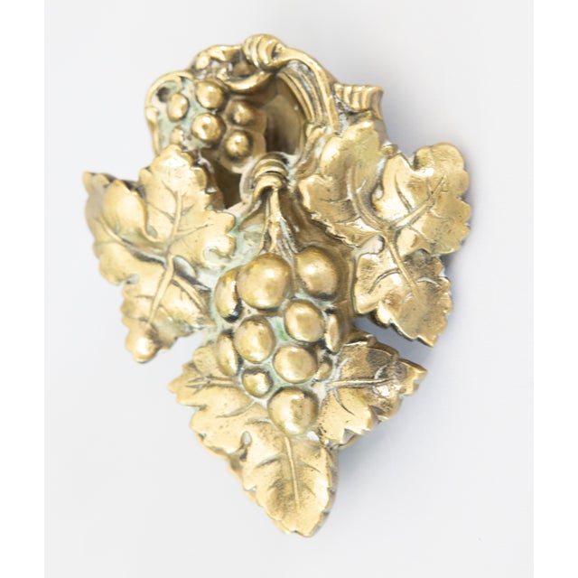 A lovely antique brass grapevine door knocker. This fine door knocker is well cast and heavy, decorated with a grape...