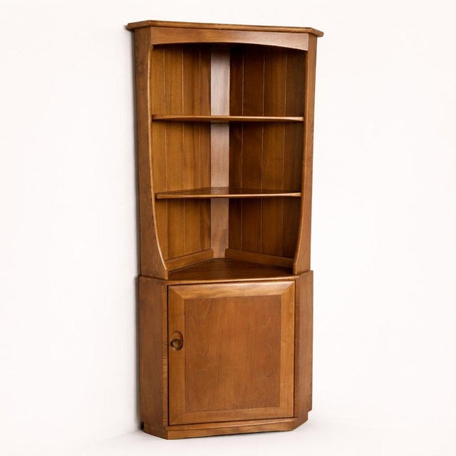 A classic mid-century corner cabinet from the sought-after Golden Dawn range by Ercol . Crafted in beautifully toned elm,...