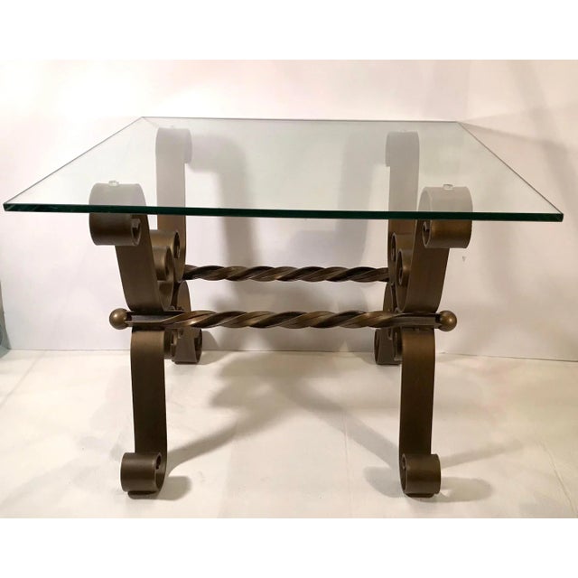 Modern scrolled gold metal & glass top side table. Very elegant. Glass is heavy and a bit tinted.