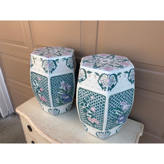 A gorgeous pair of Chinoiserie blue, white, pink, and green porcelain garden stools, plant stands, or small side tables...