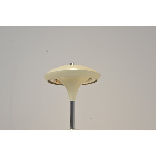 Large desk lamp design from the fifties. The lamp has a cord switch. The lightbulb is a round fluorescent tube. Varnished...