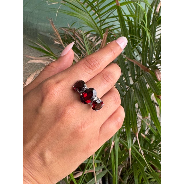 Crafted in 925 solid silver, this unisex three-stone garnet ring features three striking oval-cut garnets measuring 13X10,...