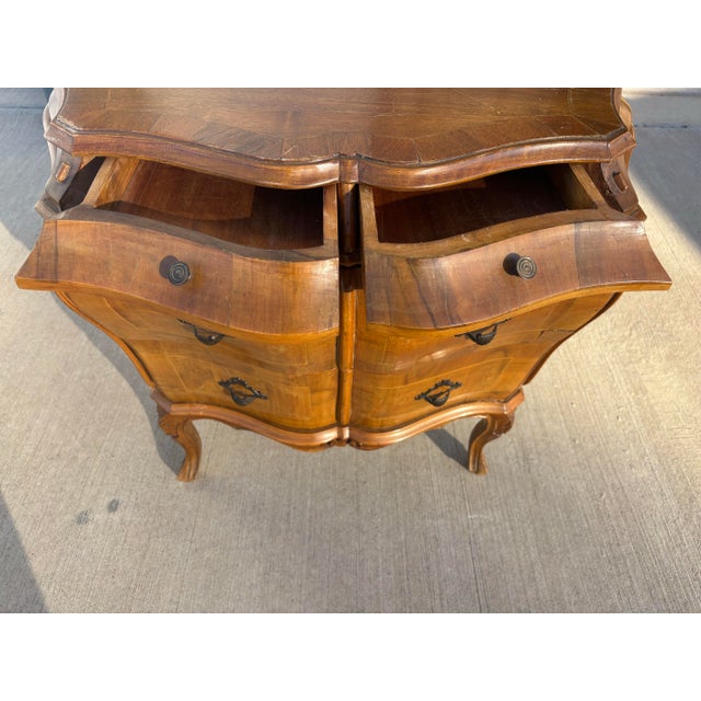 This vintage Italian olivewood Rococo bombe commode is an exquisite expression of Old World artistry, distinguished by its...