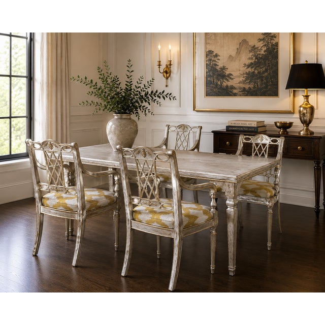 A refined set of four Maitland Smith armchairs, showcasing the brand’s signature craftsmanship. The frames are finished in...