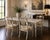 A refined set of four Maitland Smith armchairs, showcasing the brand’s signature craftsmanship. The frames are finished in...