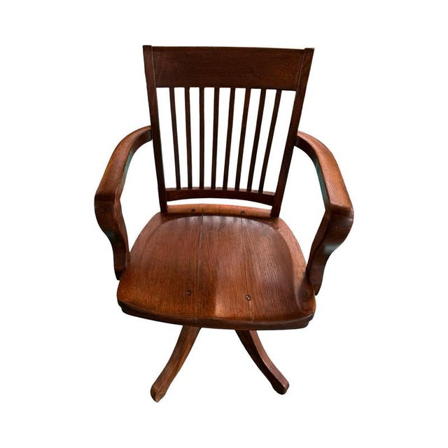 Antique oak captain's chair. The chair is adjustable in height by a spindle wich also makes it possible to swivel. The...