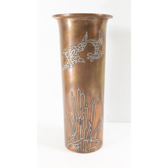 We are selling this Arts & Crafts Sterling silver overlay copper vase with bird and cattail decoration and attributed to...