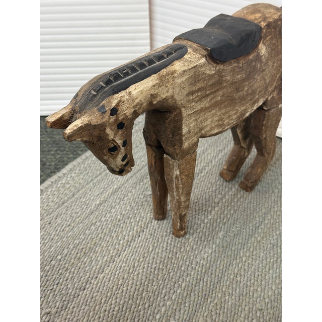 Design Plus Gallery presents a Vintage Hand-Carved Wooden Horse Sculpture. This sculptural horse is carved from wood with...