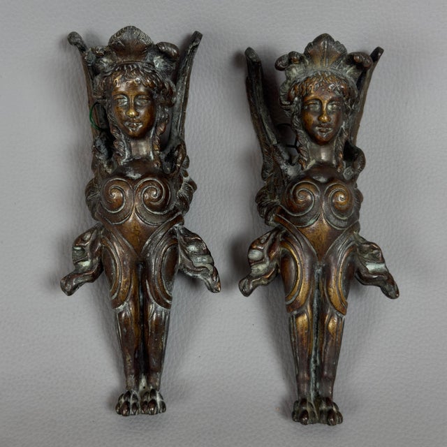 This spectacular pair of bronze sculptures was originally conceived as sophisticated decorative mouldings for fine...