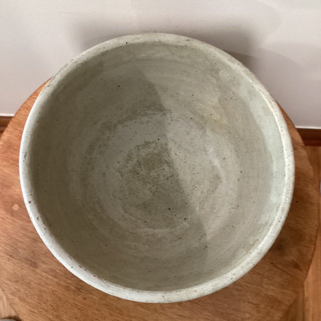 Elevate your home decor with this vintage handcrafted glazed stoneware bowl that exudes a timeless charm. The artist-...