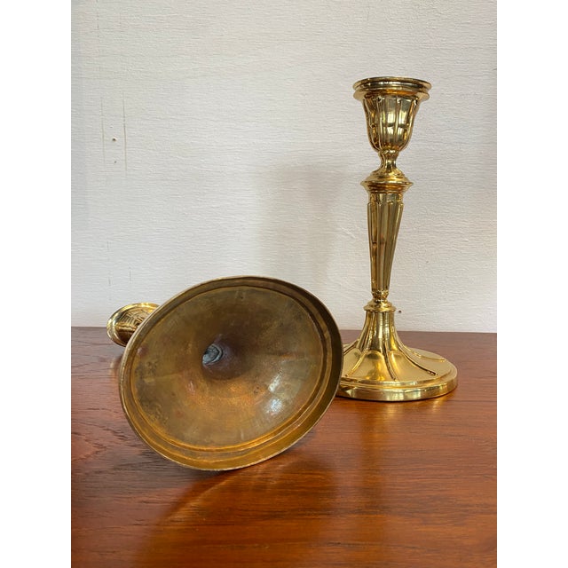 Pair of Mottahedeh polished brass candle sticks. Makers mark on bottom.