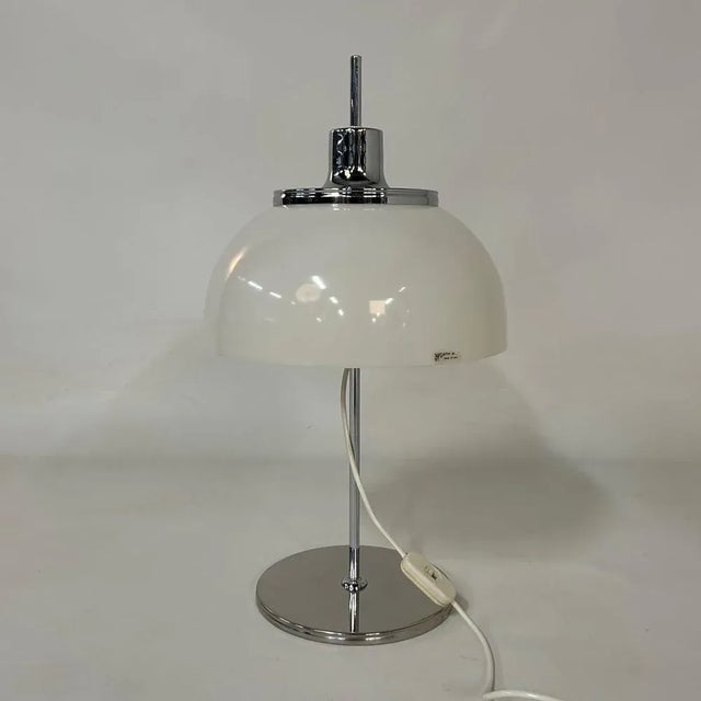 White Faro table lamp designed by Guzzini design team led by Luigi Massoni for Italian manufacturer Harvey Guzzini in...