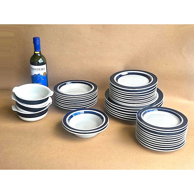 Offered is a rare vintage set of 71 pieces of Arabia stoneware dinnerware in the Anemone pattern designed by Ulla Procope....